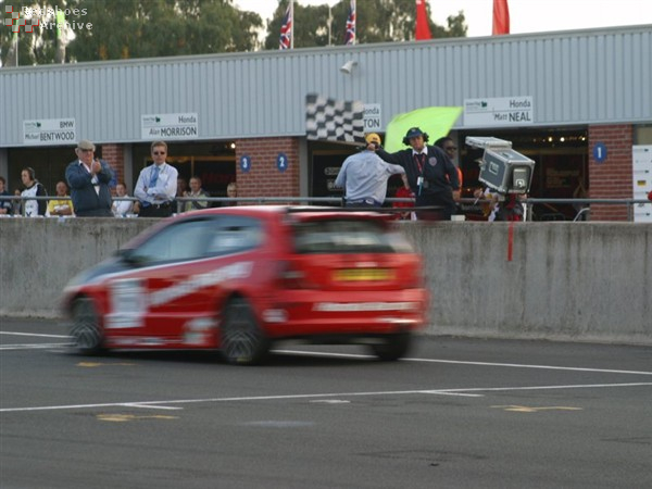 Matt Neal takes the chequered flag